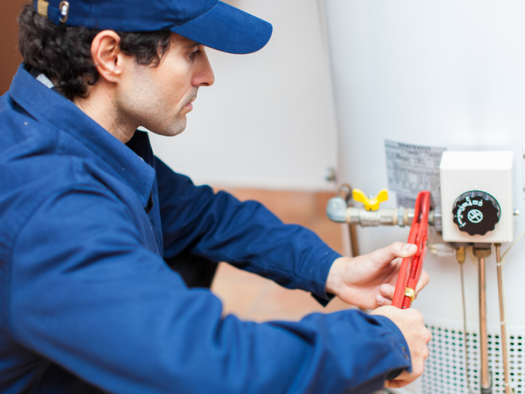 Plumber servicing a residential water heater